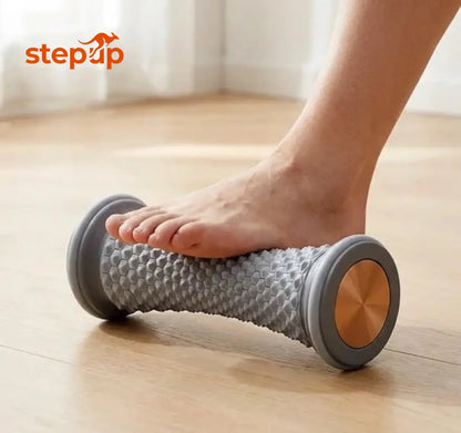 Bare foot rolling on the Stepup Foot Massage Roller on a timber floor