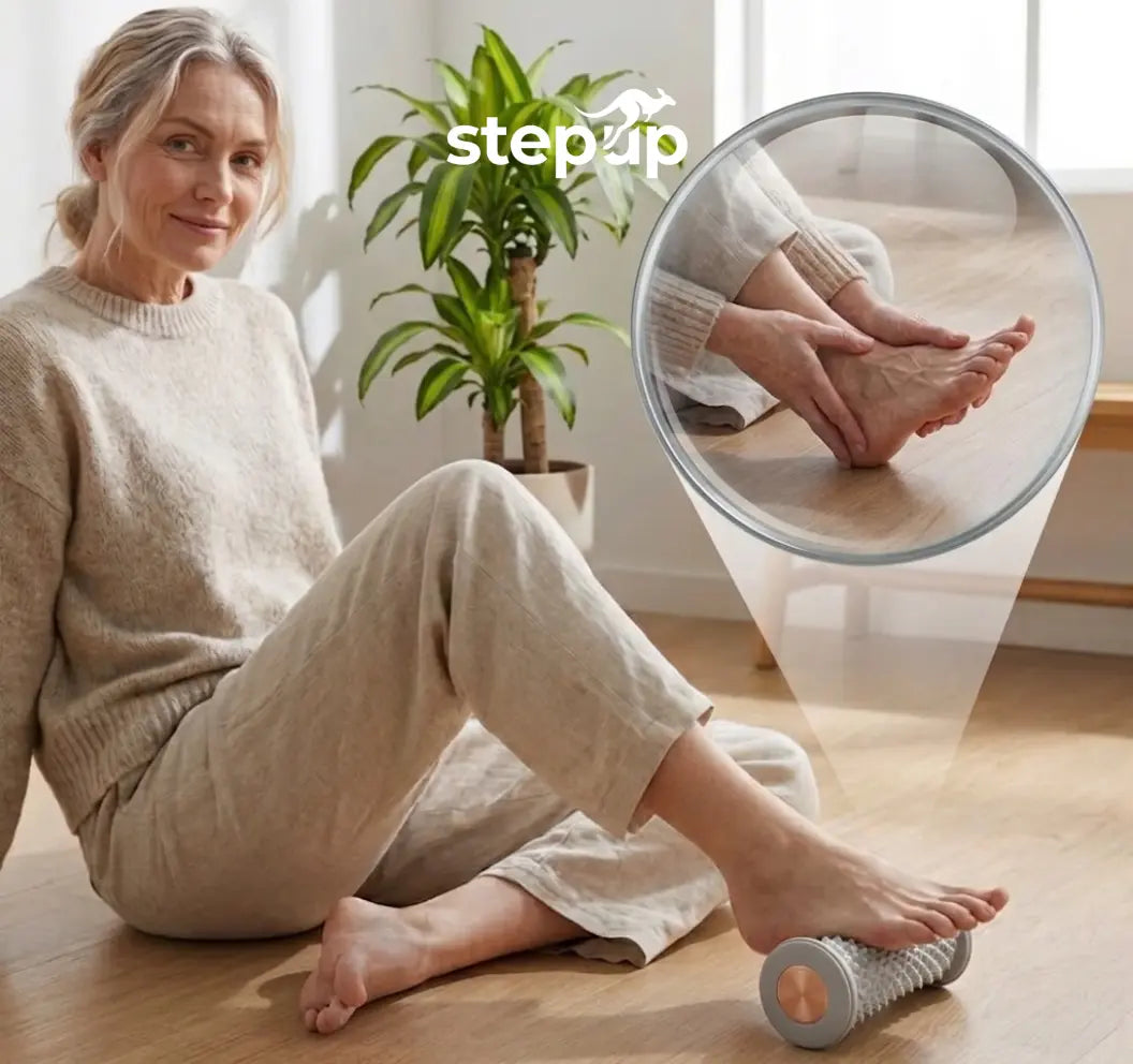 Woman sitting on the floor using the Stepup Foot Massage Roller under her foot